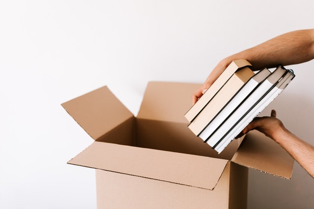 a%20person%20packing%20moving%20boxes